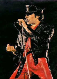 Freddy Mercury in red leather pants and black leather cap and jacket