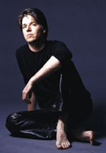 Joshua Bell in black leather pants with bare feet