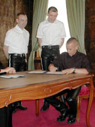 wedding: best man in leather pants signing